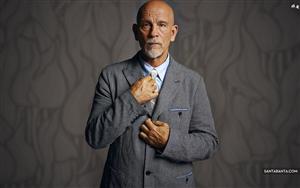 John Malkovich, an English actor, poses in a formal suit